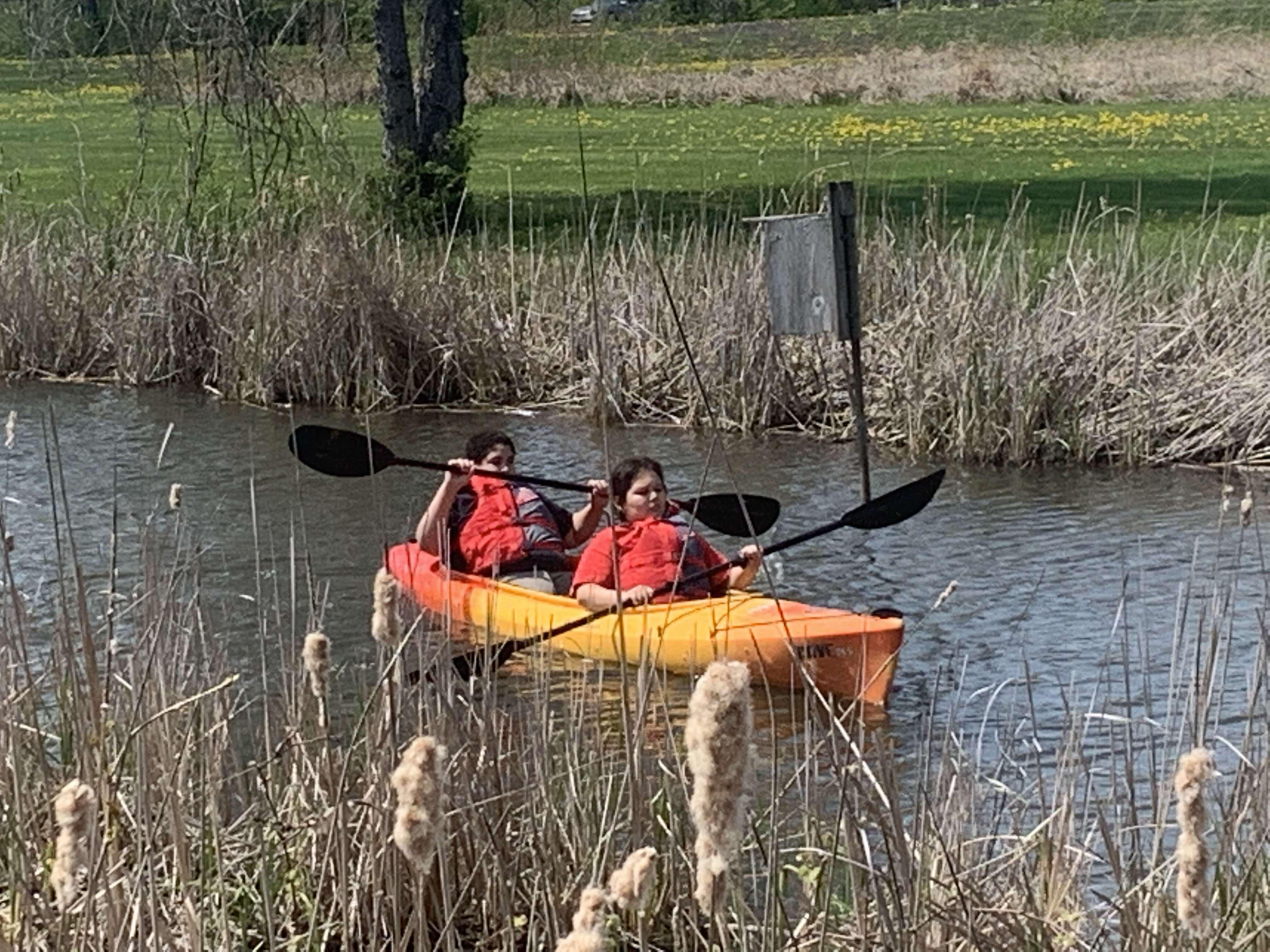 Students rowing a kayak