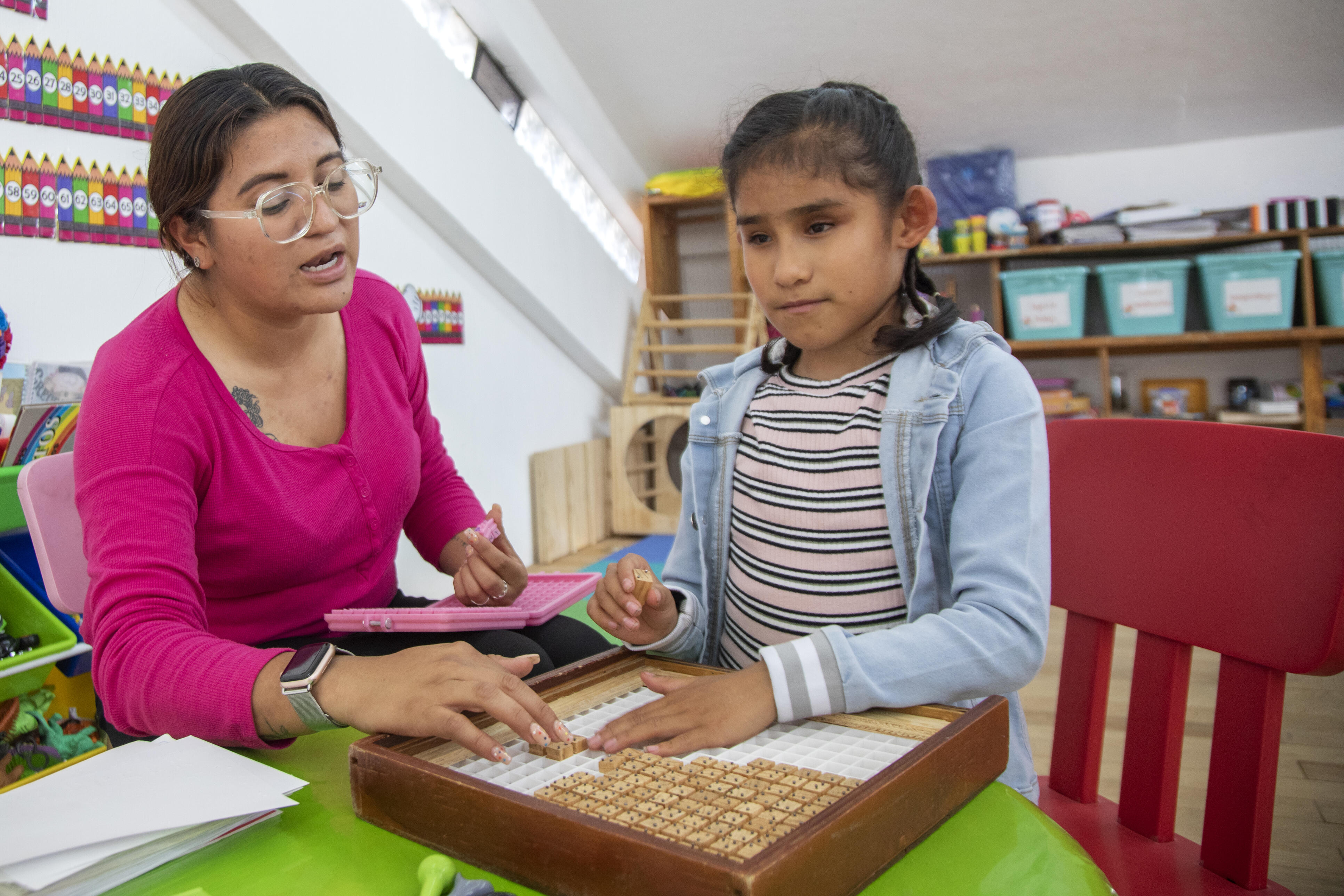 Teacher teaching math to blind girl